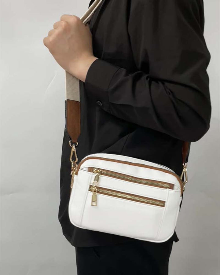 Close-up of the embroidered detail on a women's black PU leather crossbody fashion bag