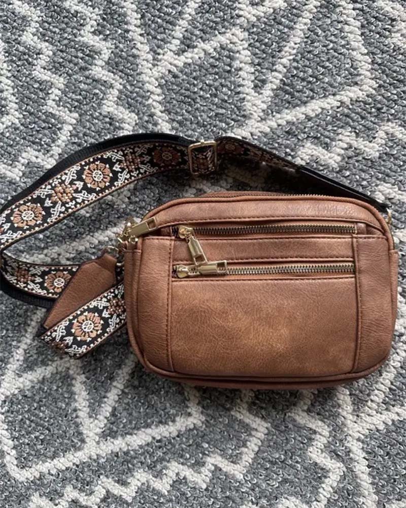 Women's versatile black PU leather crossbody handbag, front view, with secure zipper closure