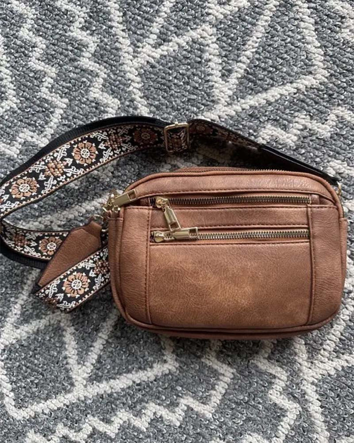 Women's versatile black PU leather crossbody handbag, front view, with secure zipper closure