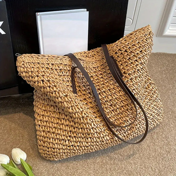 Elegant woven straw shoulder bag for women, a stylish accessory for beach and summer.