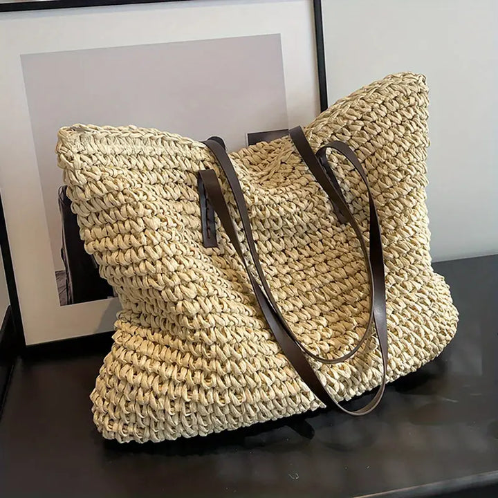 Durable women's woven straw tote bag, designed for beach, summer, and travel comfort.