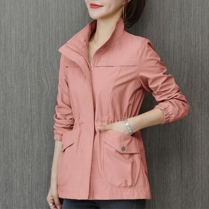 Solid color women's everyday wear jacket. Stand-up collar transitional outerwear with zipper closure.