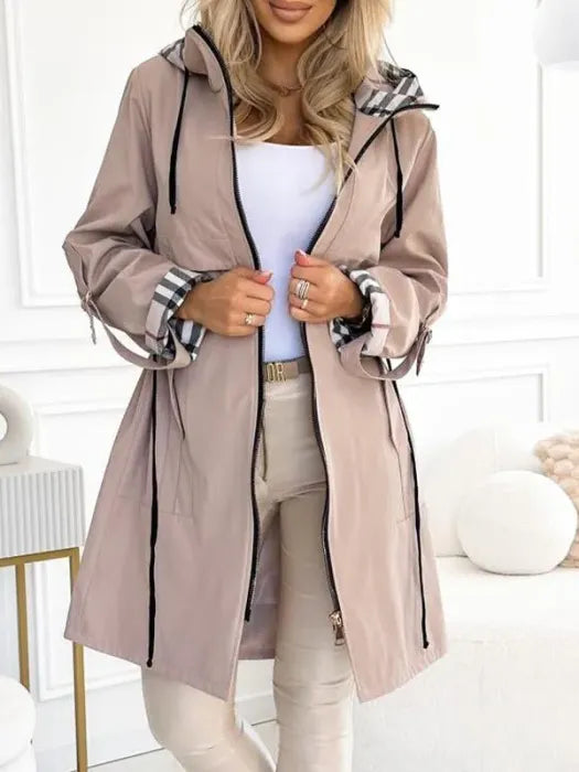 Lightweight women's waterproof hooded jacket, offering windproof protection for versatile all-weather outdoor wear.