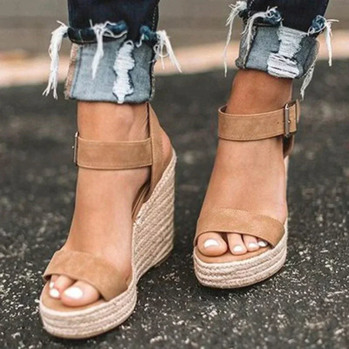 Women's stylish wedge woven sandals with adjustable buckle. Comfortable open-toe summer footwear for casual chic.