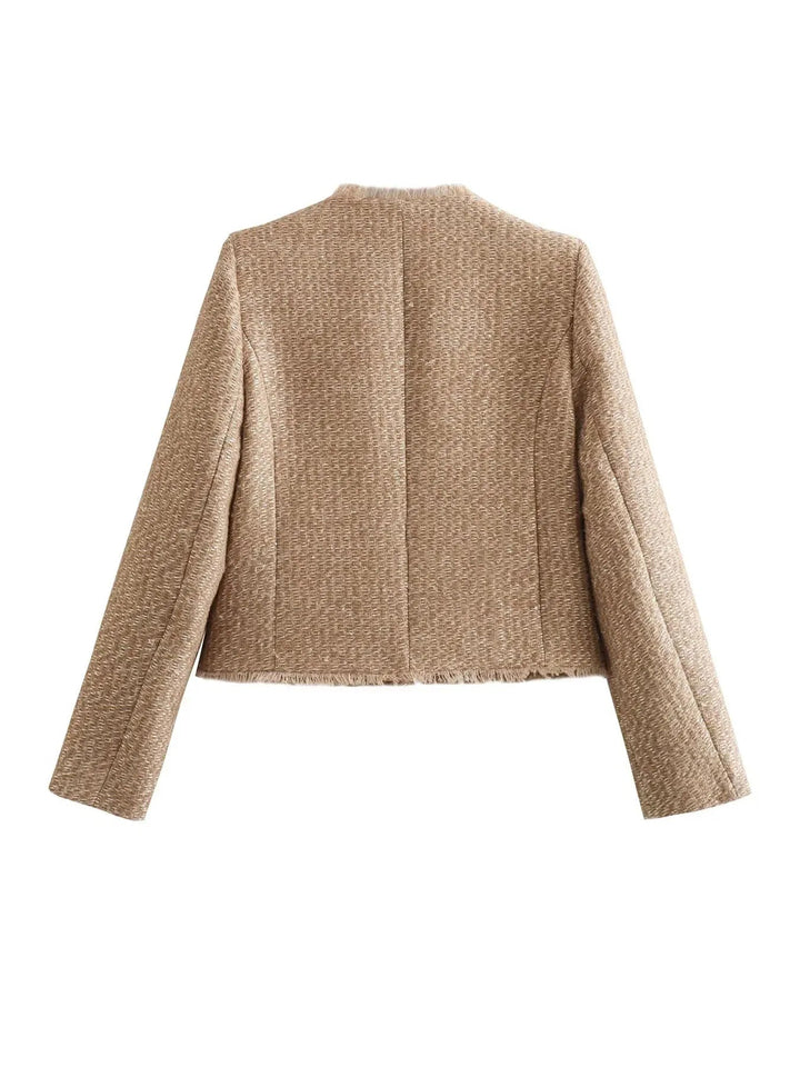 Fashionable women's tailored jacket, a chic cropped blazer with fringed edges for a modern look.