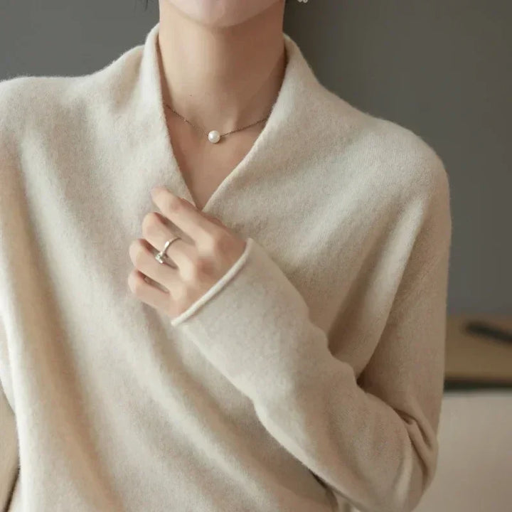 Detail shot of the stylish wrap neck design on a comfortable long sleeve women's spring top.