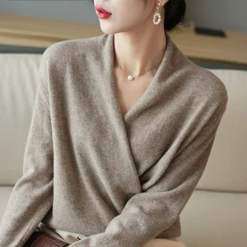 Stack of women's knit wrap neck tops in various spring colors, highlighting versatile apparel.