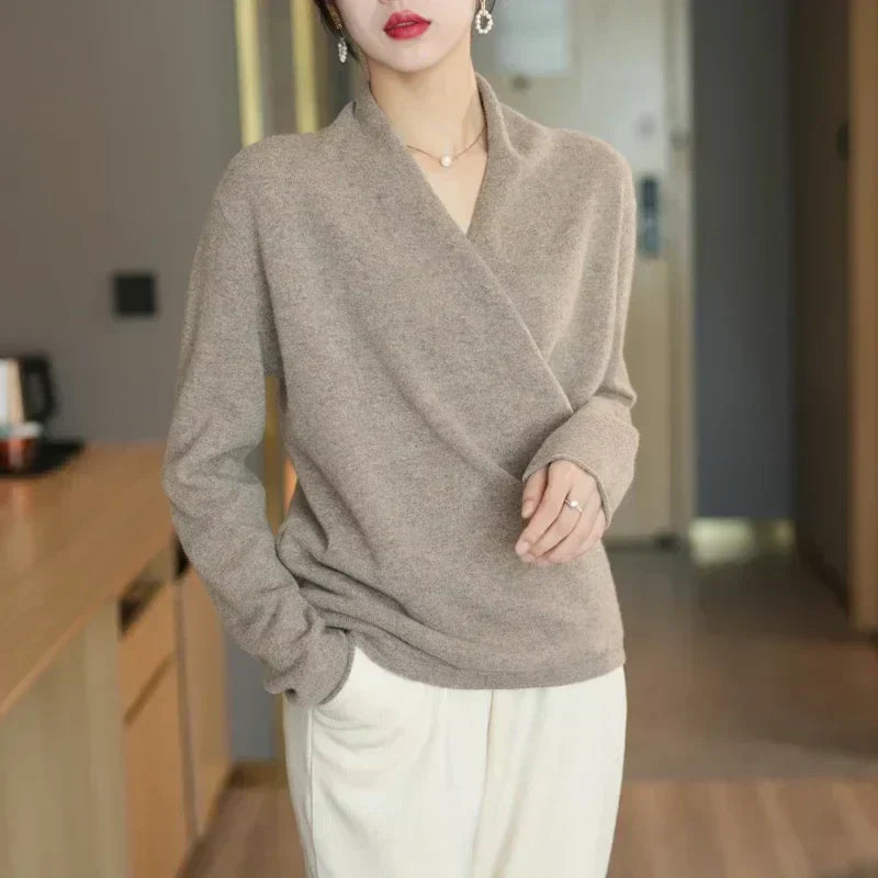 Flat lay of a women's knit wrap neck top, showcasing its lightweight material and elegant design.