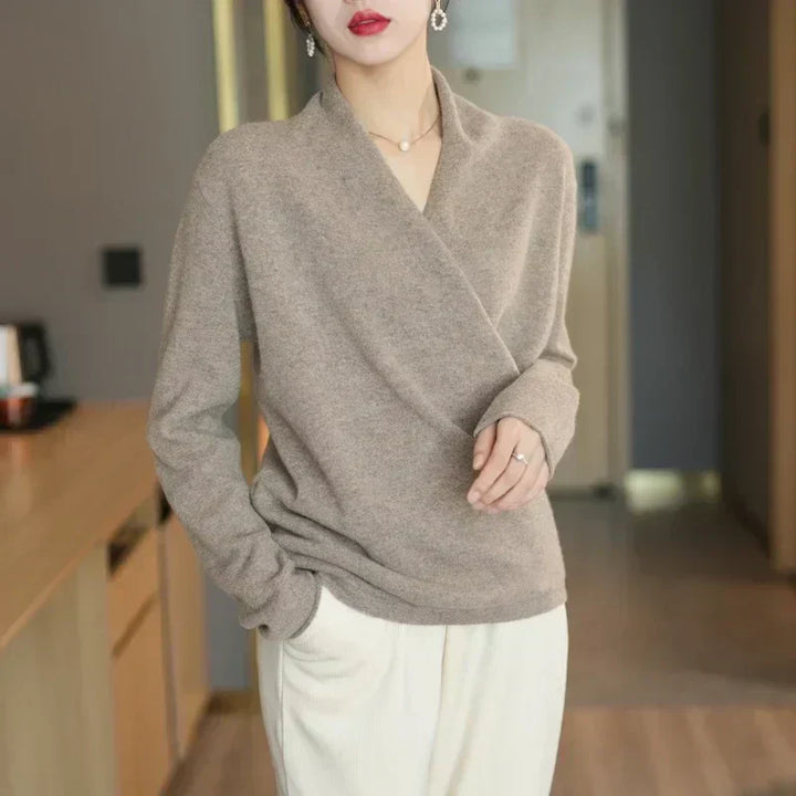Flat lay of a women's knit wrap neck top, showcasing its lightweight material and elegant design.