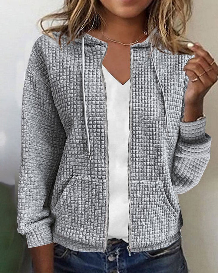 Women's textured zip-up hoodie jacket in cozy fabric, featuring a relaxed fit, hooded design, and front pockets.