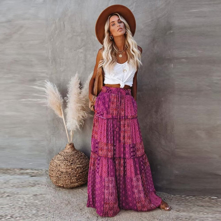 Elegant women's tiered maxi skirt featuring vibrant floral print & comfortable elastic waist. Great for summer.