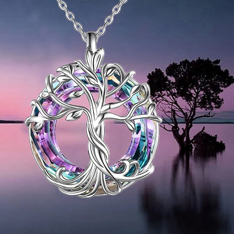 Close-up of a women's Tree of Life pendant, showcasing detailed silver-tone branches and embedded crystals.