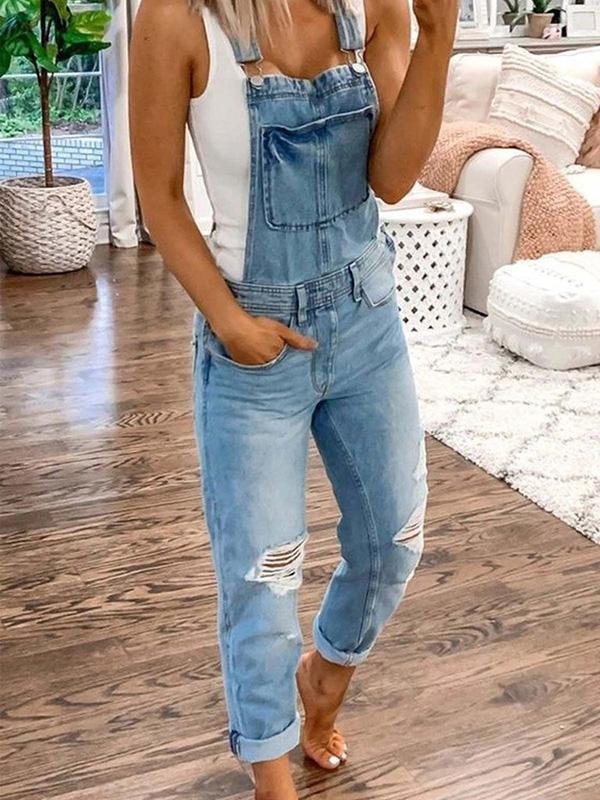Modern women's fashion: a trendy ripped denim jumpsuit, ideal for a stylish, casual spring summer look.
