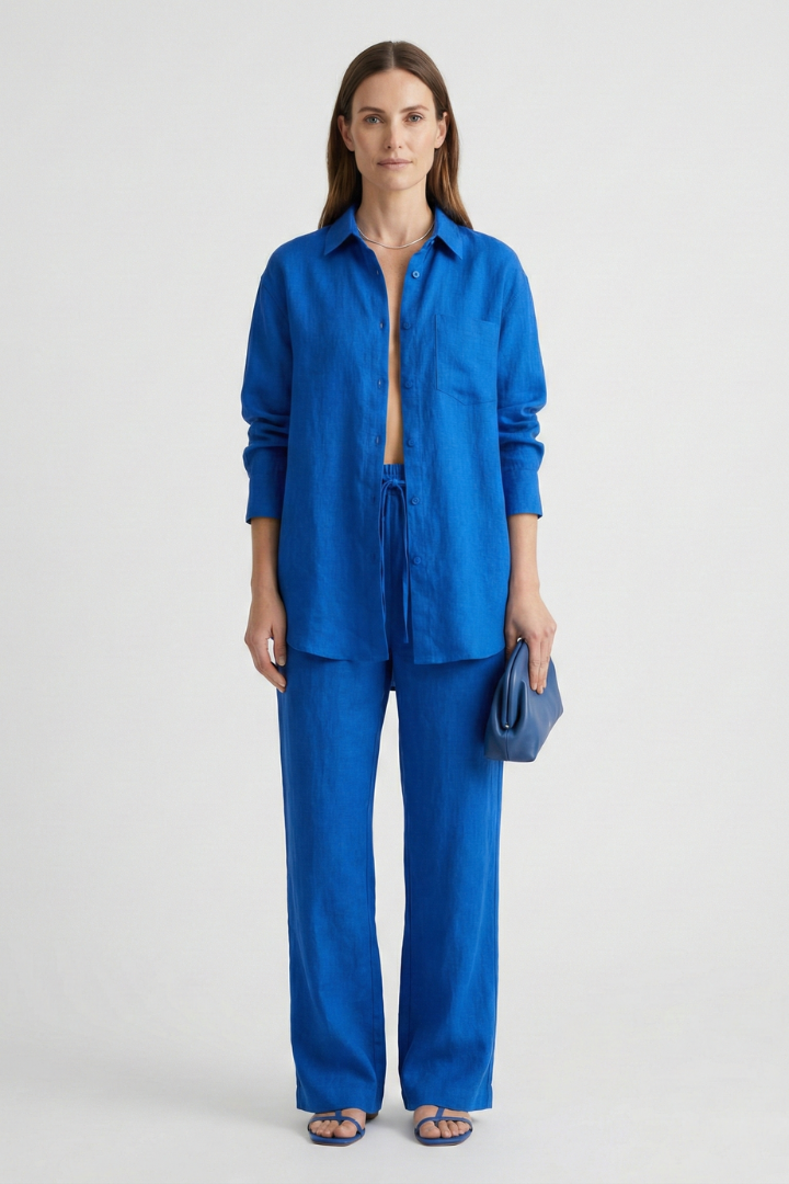 Modern women's matching set: button shirt & straight leg trousers for smart casual or office wear.