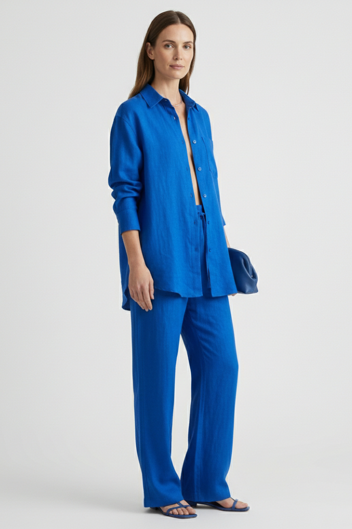 Women's matching button-up shirt and straight leg trousers two-piece set. Casual chic style.