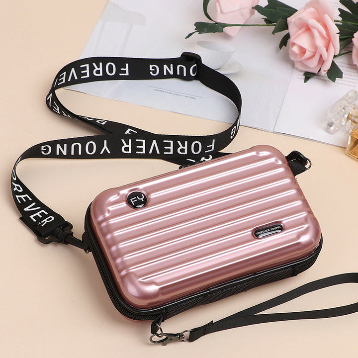 Detailed shot of the handle on a women's unique mini suitcase crossbody bag