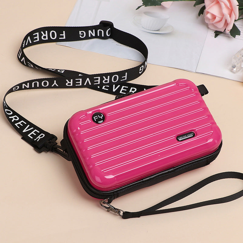 Open view of a Women's unique mini suitcase crossbody bag revealing interior space