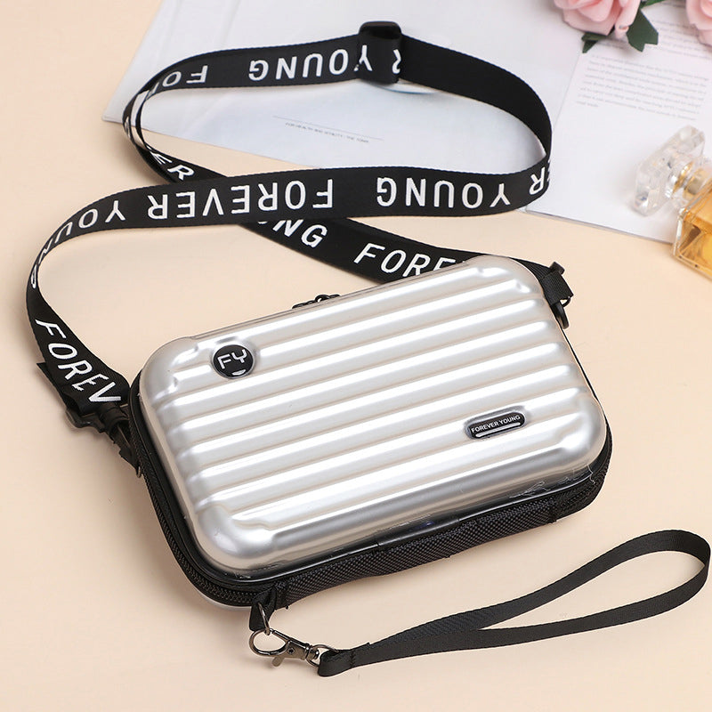 Women's mini suitcase crossbody bag featuring a durable PVC construction