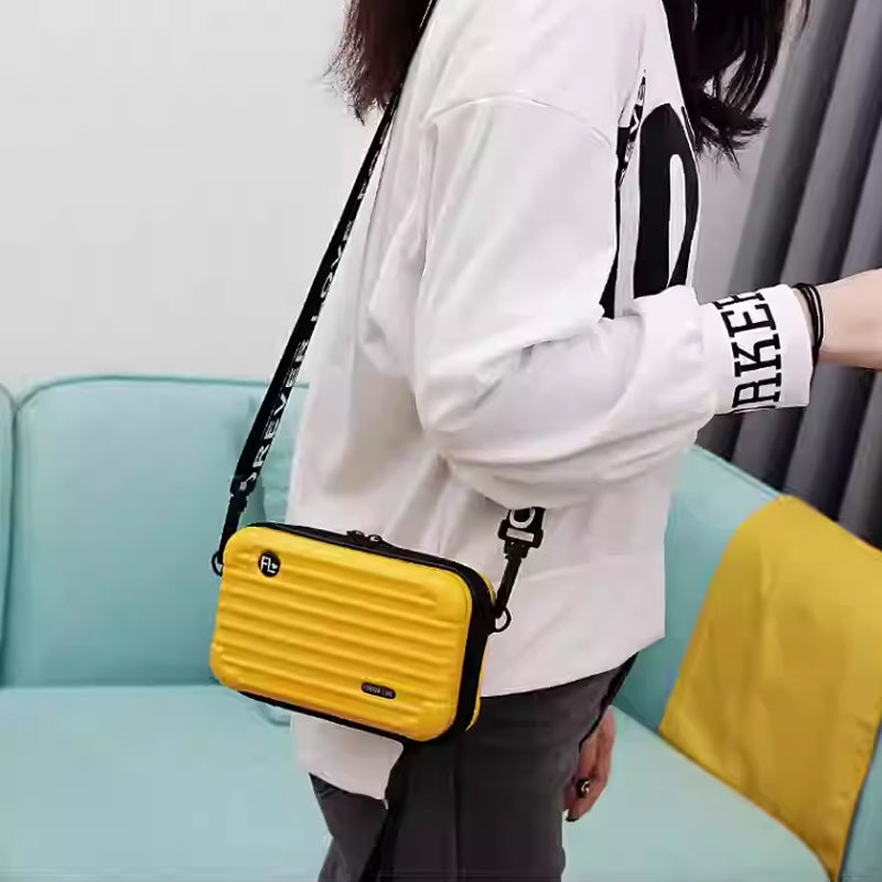 Close-up of a Women's unique mini suitcase crossbody bag showing texture and zipper