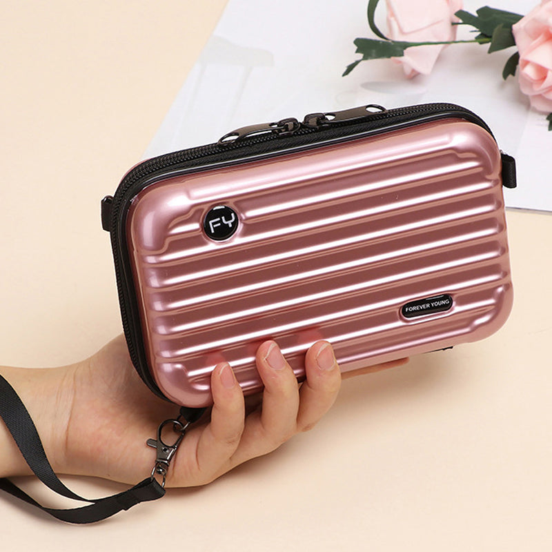 Side view of a Women's unique mini suitcase crossbody bag, showcasing its compact size