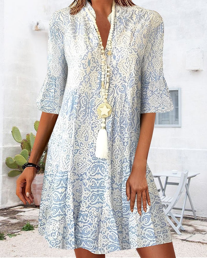 Elegant women's V-neck A-line mini dress with bell sleeves & floral print, ideal for brunch or day wear.