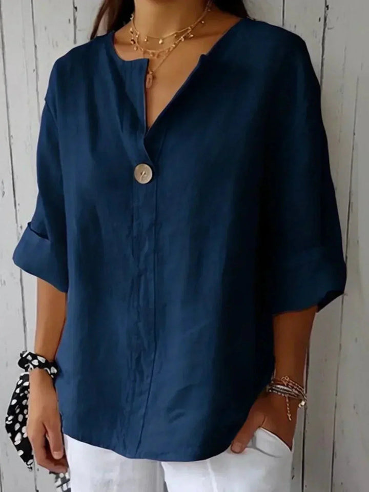 Travel-friendly women's V-neck blouse with roll tab sleeves. A versatile long sleeve button-down for spring/summer.