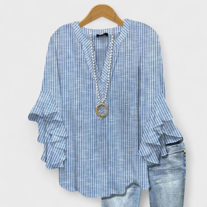 Trendy spring/summer V-neck blouse for women, featuring stylish ruffle sleeves & loose fit.