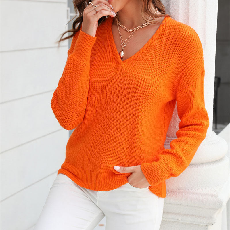Side view of women's V-neck loose fit sweater. Shows relaxed fit & long sleeves, versatile knit top.