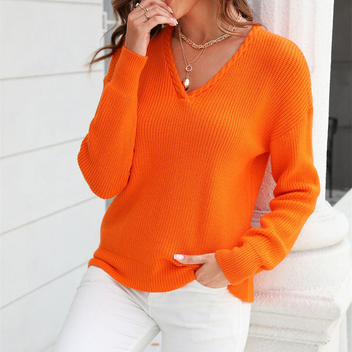 Side view of women's V-neck loose fit sweater. Shows relaxed fit & long sleeves, versatile knit top.