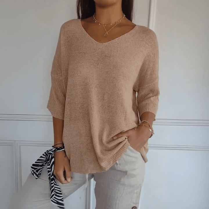 Stylish women's V-neck sweater with loose silhouette & three-quarter sleeves. Perfect for casual comfort.