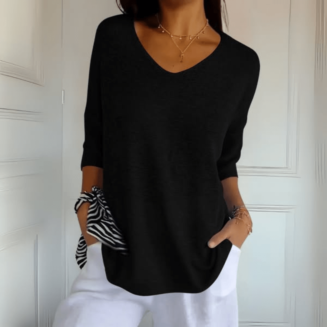 Effortless women's V-neck sweater with a loose fit & three-quarter sleeves. Great for casual fashion.