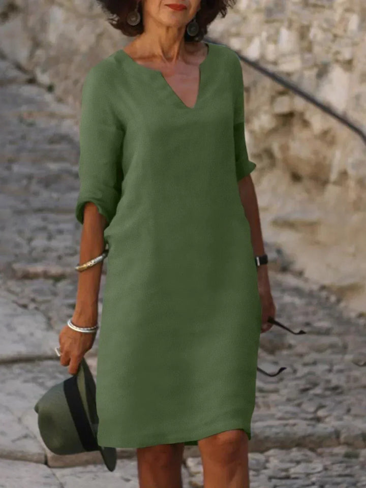 Comfortable women's v-neck midi dress with three-quarter sleeves & pockets. Relaxed fit for everyday wear.