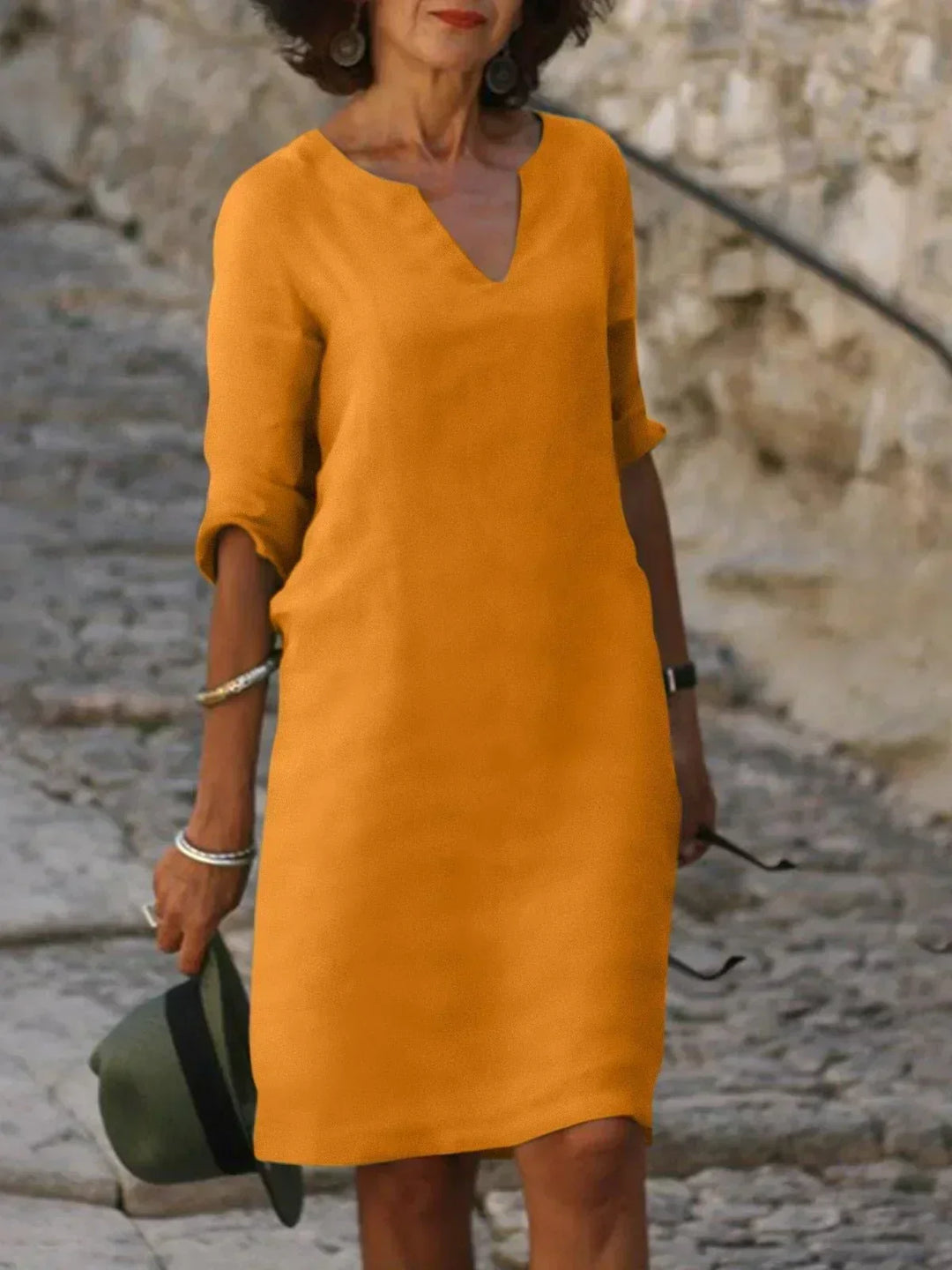 Elegant women's v-neck midi dress with three-quarter sleeves. Relaxed fit, versatile for casual to elegant.