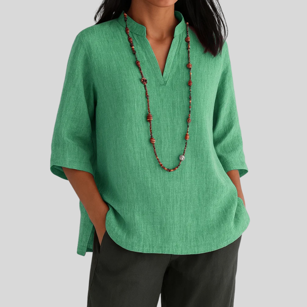 Women's V-notch blouse with three-quarter sleeves, perfect for casual chic or office wear. Flowy, versatile top.