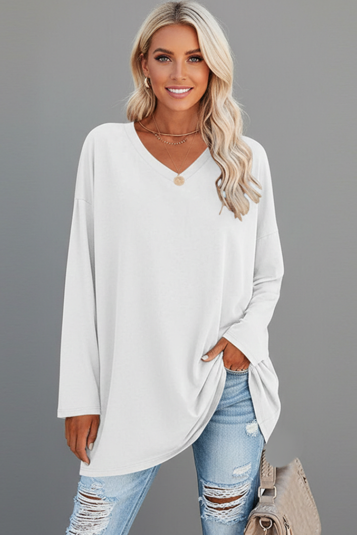 Back view of a women's pull-on long sleeve v-neck top, highlighting its loose fit and comfortable design.