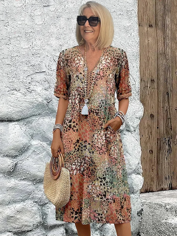 Effortless women's vibrant print flowy midi dress. Versatile casual or elegant style with functional pockets. Spring/summer.