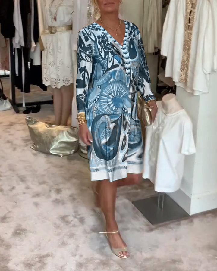 Artistic sunburst print enhances this women's flowing tunic dress, a true statement for spring fashion.