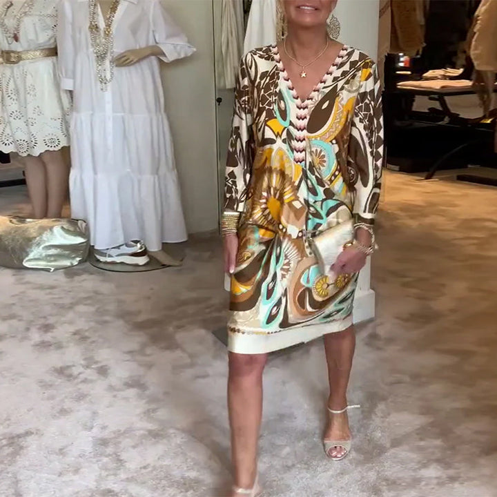 Women's sunburst print tunic dress, a vibrant and flowing piece for all your spring and summer events.