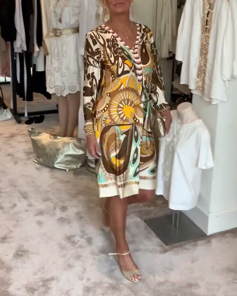 Flowing women's summer dress featuring a unique artistic sunburst print, great for beach or casual outings.