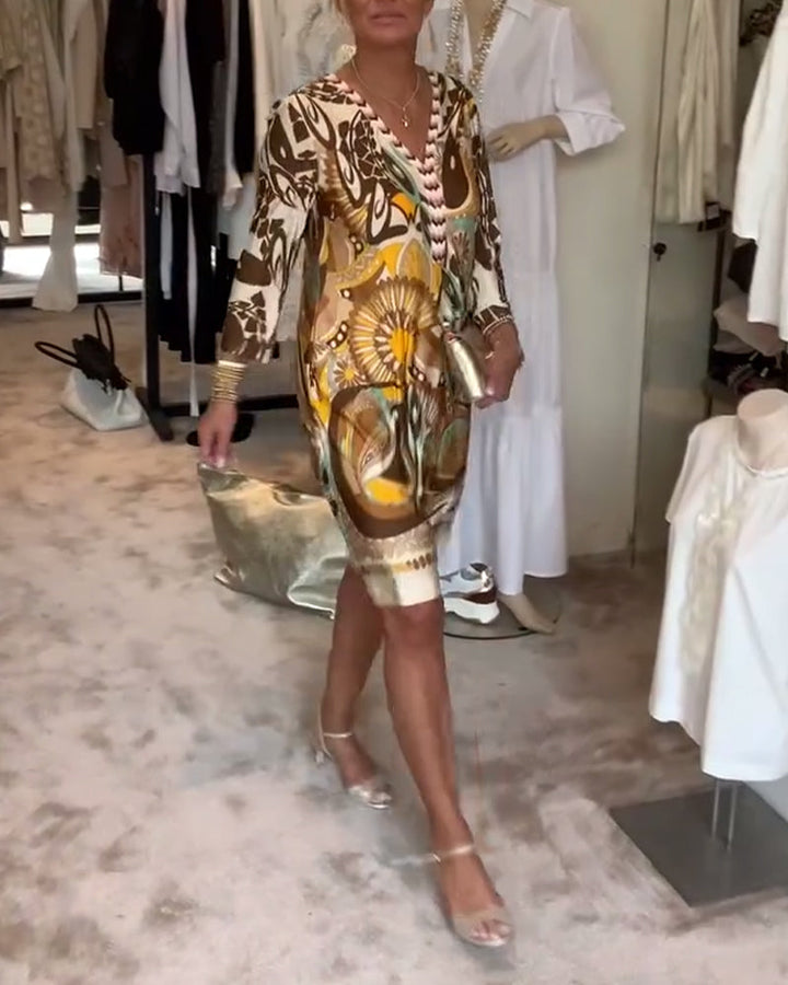 Statement women's flowing tunic dress with a bold, artistic sunburst print for a bohemian look.