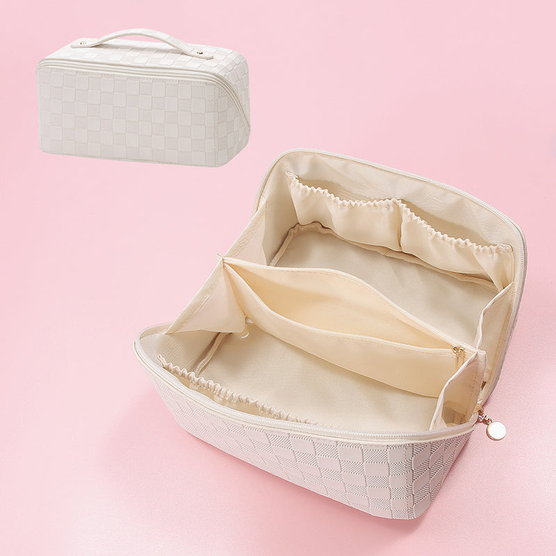 Women's cosmetic bag in vintage pattern next to everyday essentials, travel ready