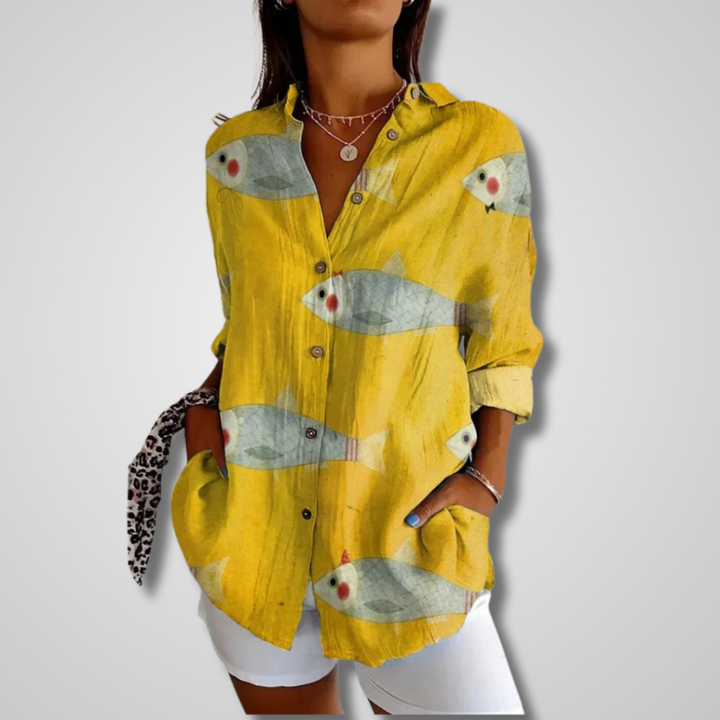 Stylish women's vintage print blouse. Features v-neck, button-down front, and long sleeves for a boho look.
