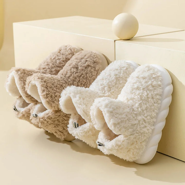 Warm ladies' cotton slippers with plush lining. Slip-on home wear offering cozy comfort for indoor & outdoor use.