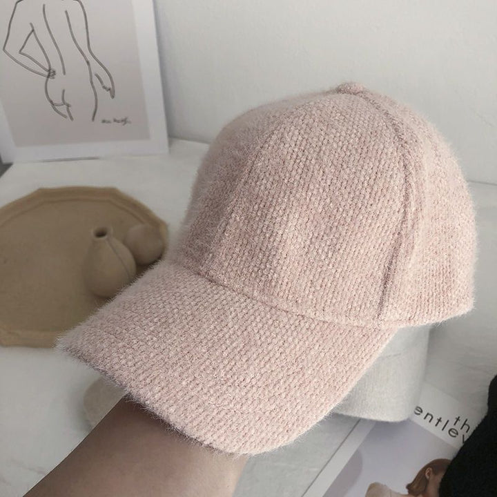 Comfortable women's faux fur winter baseball cap, stylish and cozy for the cold season.