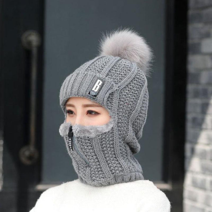 Close-up of the windproof material on a women's winter hat, showing weather resistance