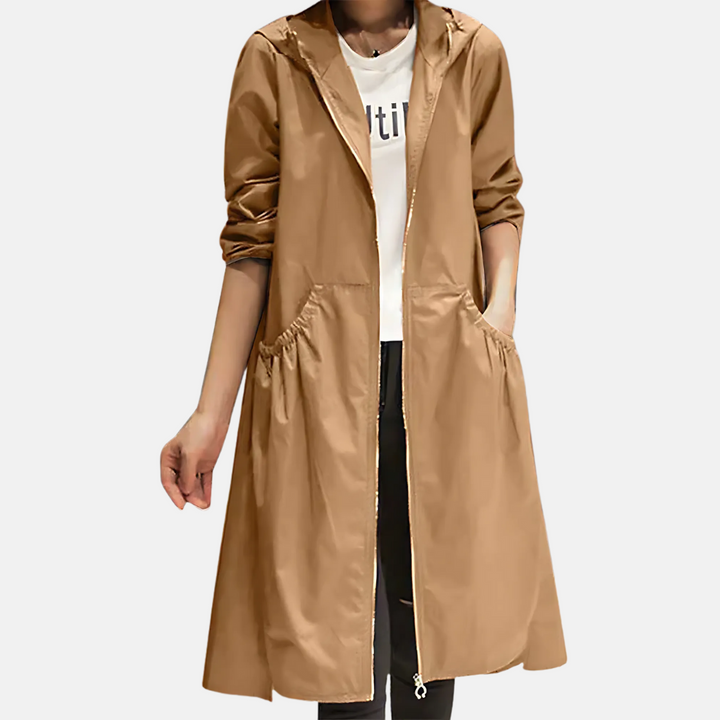 Stylish women's hooded rain jacket. Knee-length, water-resistant for travel and daily wear. Essential fall outerwear.