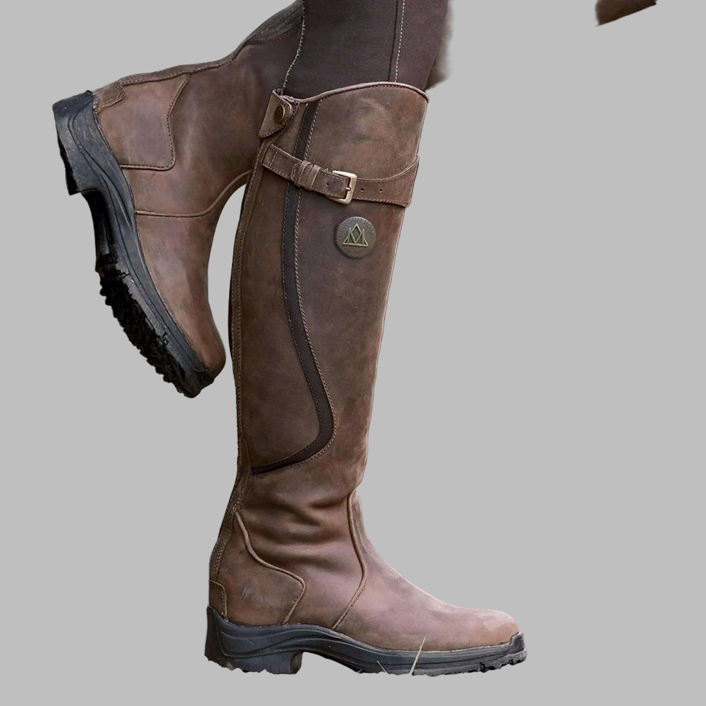 Women's waterproof equestrian riding boots with secure grip sole, tall design, and all-weather performance.