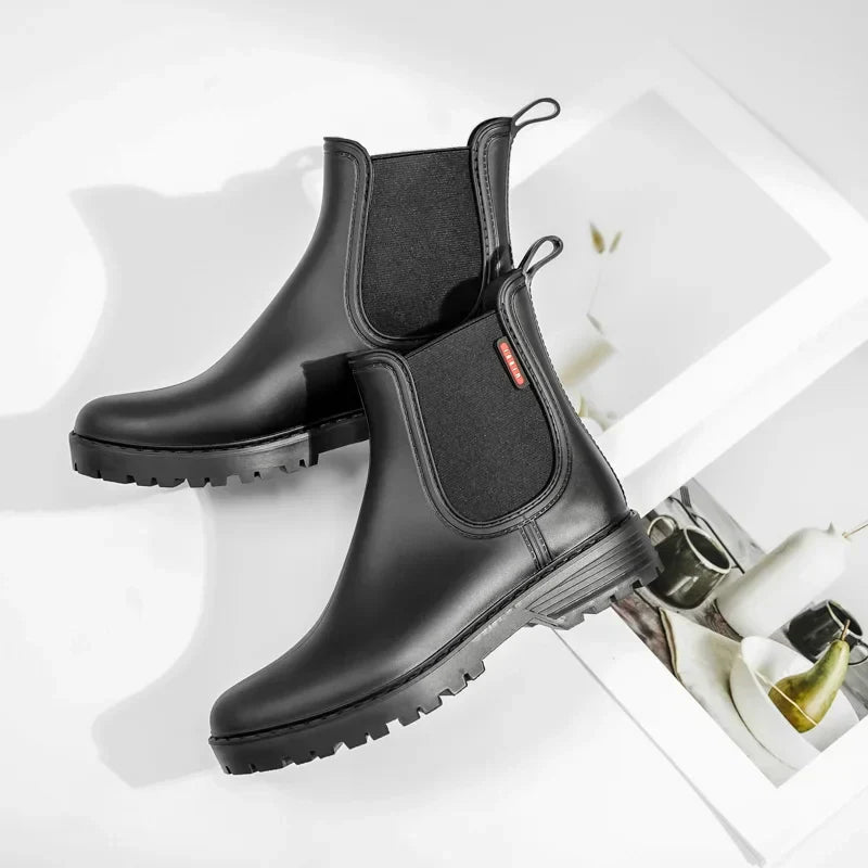 Classic black Chelsea boots for women, featuring waterproof and insulated design for winter.