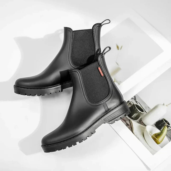 Classic black Chelsea boots for women, featuring waterproof and insulated design for winter.