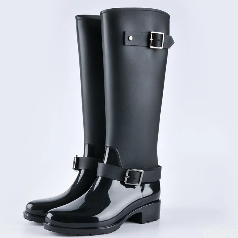 Women's waterproof knee-high rain boots with stylish buckles & practical block heels for wet weather.